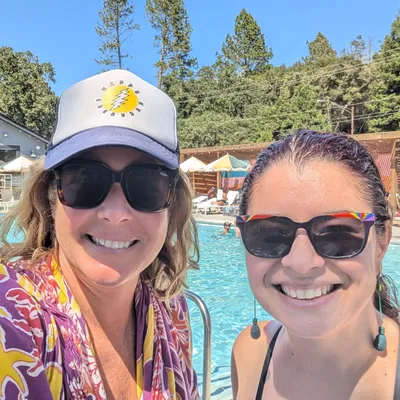 Megan and Adri with a pool in the background