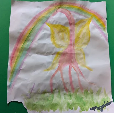 A girafe with butterfly wings walking on grass with a rainbow in the background